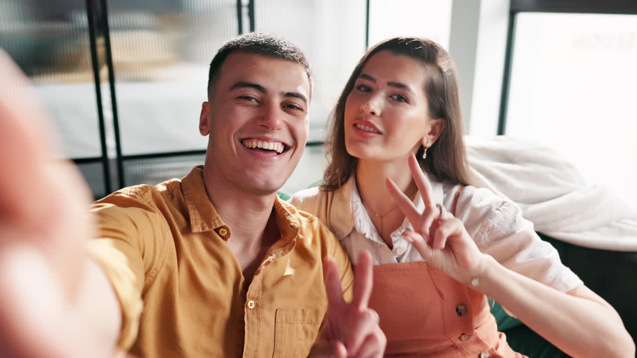 Couple taking a selfie while making peace signs
