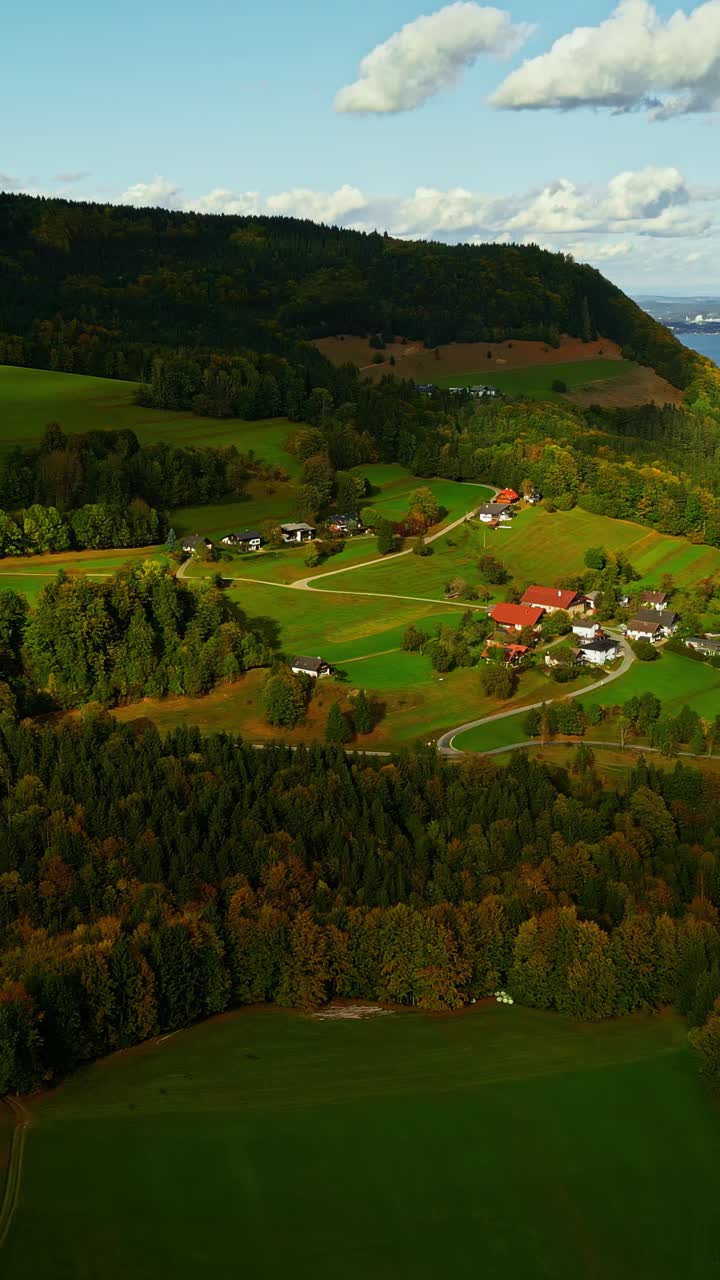 Vertical View Of Rural Village Nestled Near Mountains And Forest. Aerial Shot