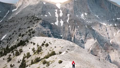 adventurous hiker crosses the high alpine plateau in mount olympus in greece - tilt-up shot