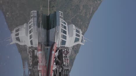 a trawler yacht docked in harbor in patagonia, a slow motion vertical shot of the boat with it's reflection on the water