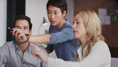 group of business people using computer at meeting