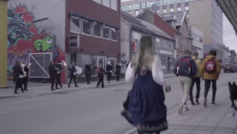 musical band parade in the street in tromso, norway. norwegian constitution day. wide shot
