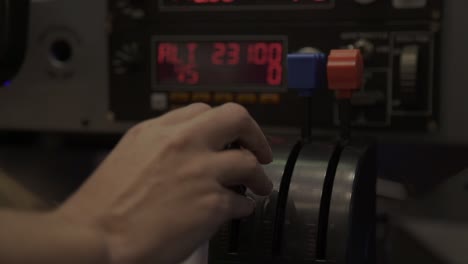 close of a hand pulling a lever in a flight simulator cockpit