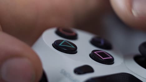 close-up of a person's hand holding and using a video game controller