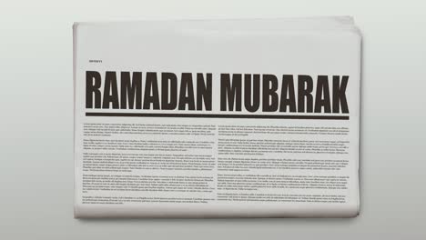 rotating newspaper animation with a text which is ramadan mubarak.