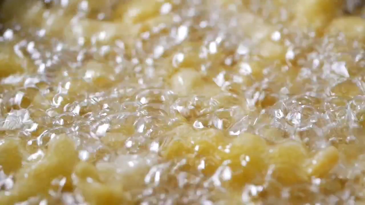 Close-up of French Fries Deep Frying in Hot Oil