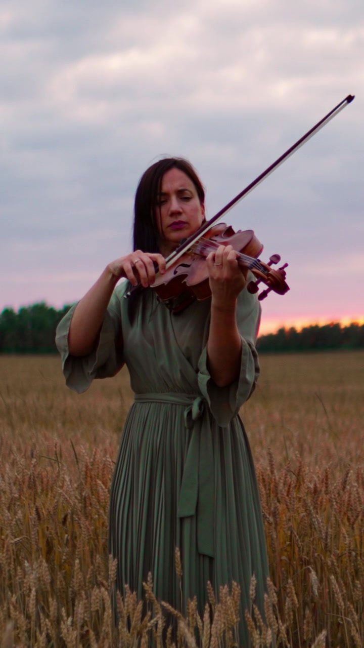 Woman Playing Violin in a Wheat Field at Sunset