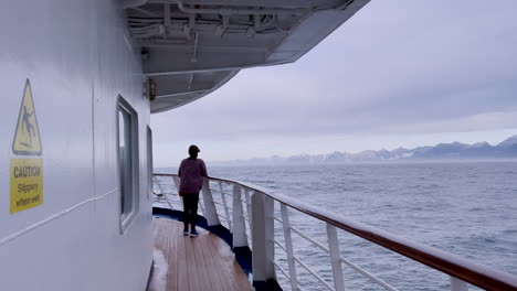 woman standing on the deck of a ship at sea