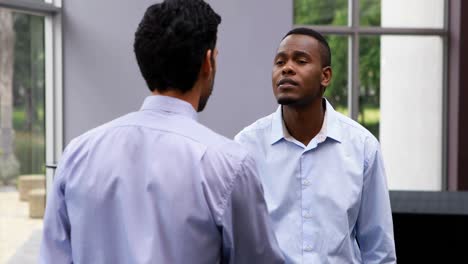 executives shaking hands while interacting