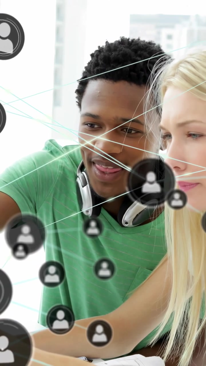 Vertical video: Man pointing woman tapping pad starting node icons layering them showing tech links