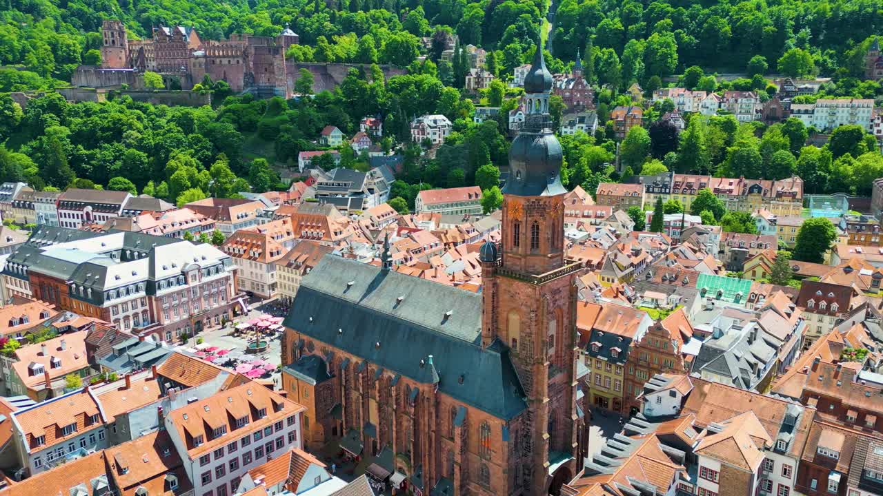 4K Aerial Drone Video of Historic Heiliggeistkirche Church with Castle on Königstuhl Hill overlooking Heidelberg, Germany