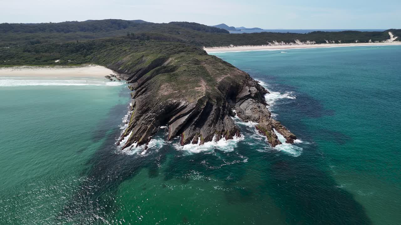 Aerial view of the rocky headland Treachery Head and white sand beaches along the coastline of Seal Rocks Australia