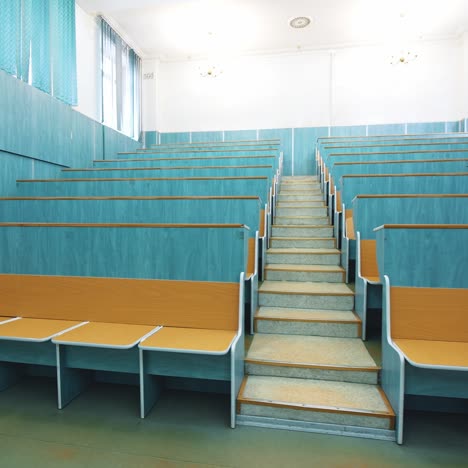 comfortable classroom without students. empty auditorium with wooden desks in blue color. light lecture hall in the university