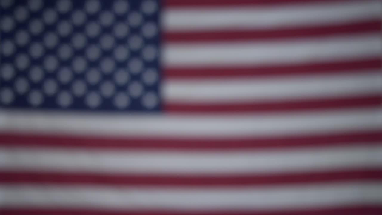 manos de una persona con pasión por los viajes que sostiene una caja de monedas guardadas para el fondo de viaje con la bandera de américa en un fondo borroso