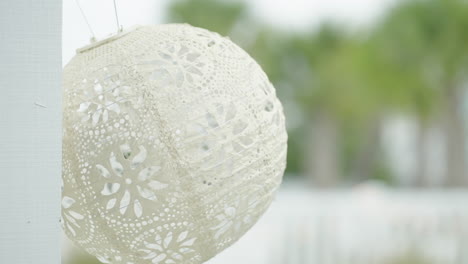 paper lantern hanging on wall at wedding venue panning shot