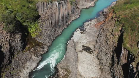 basalt river canyon of studlagil in volcanic landscape of iceland