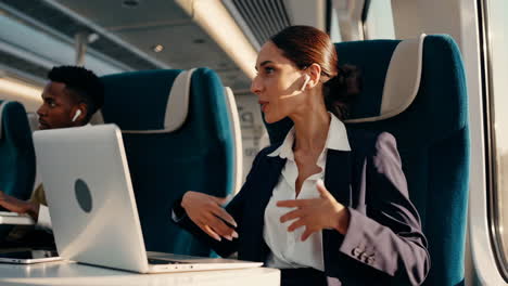 professional woman working on laptop during a train commute