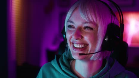 Caucasian-young-woman-playing-game-at-night-among-neon-lightning