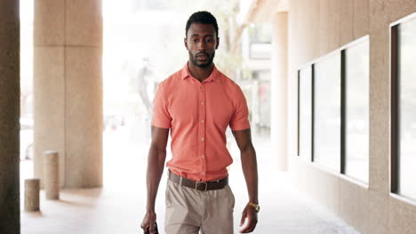 businessman walking in a city corridor