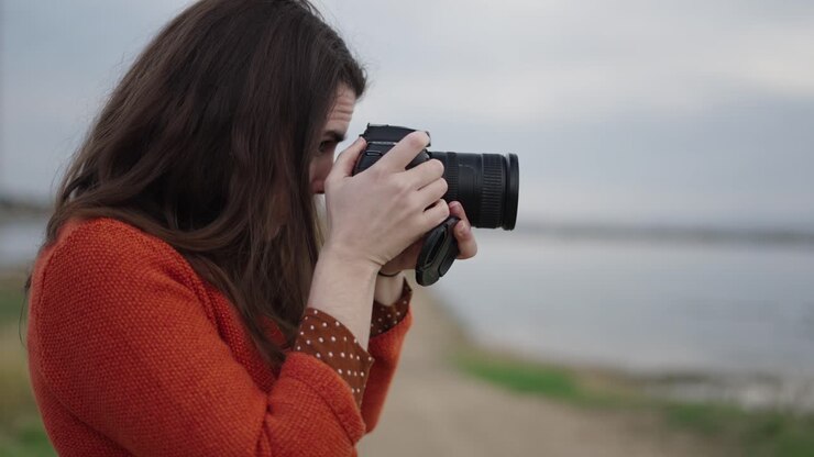 Woman taking photo by the lake