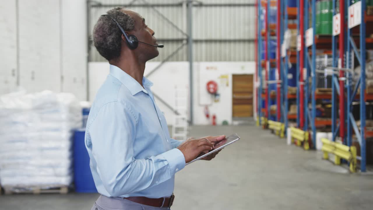 Male warehouse worker using tablet computer 4k