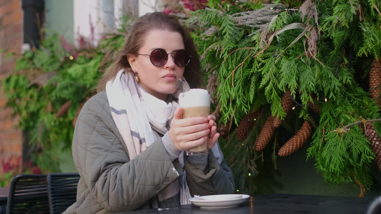 Woman enjoying a latte in an outdoor cafe