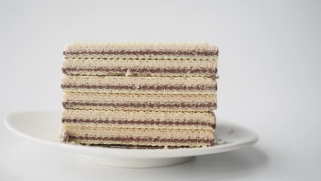 stack of chocolate-covered wafers on a plate