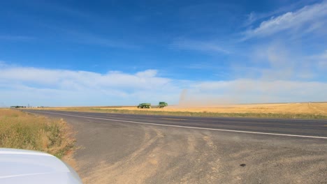 Combine-harvester-and-tractor-with-grain-trailer-are-harvesting-the-wheat-field-in-eastern-central-Washington-state