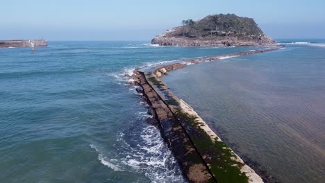 Drone-aerial-view-of-the-San-Nicolás-island-at-the-beach-of-Lekeitio-in-the-Basque-Country