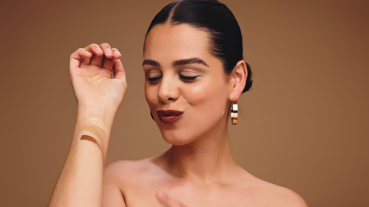 Woman testing foundation shades on her arm