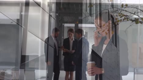 animation of office building over business people talking in modern office