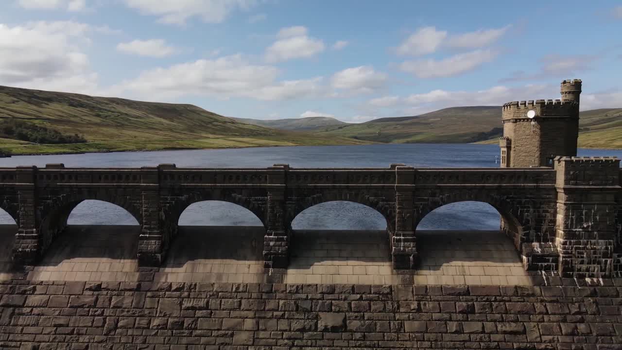 Scar House Reservoir In North Yorkshire, England - Historic Stone Dam With Arched Spillways And Turreted Tower. closeup, sideways shot