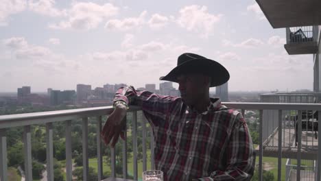 Push-in-shot-of-black-man-with-cowboy-hat-smiling-at-camera