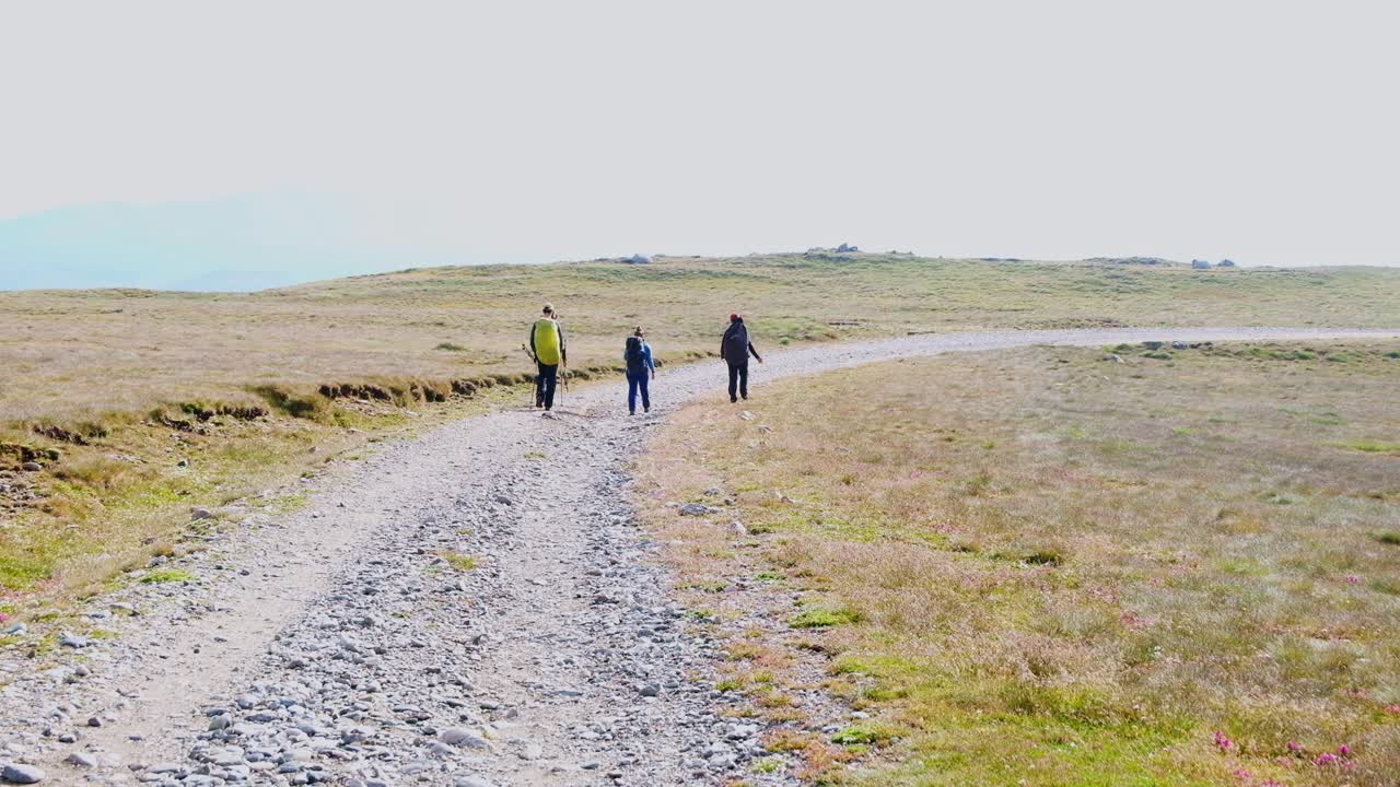 Scenic view of walking tourists on Bugeci Mountains of Brasov in the morning, Romania