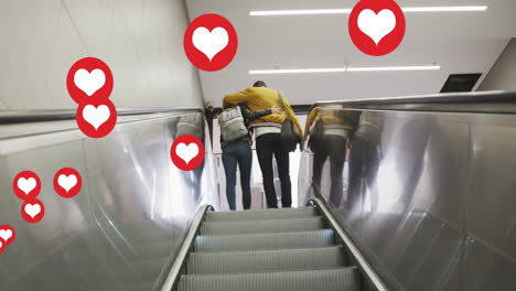 animation of heart icons floating over couple embracing on moving stairs