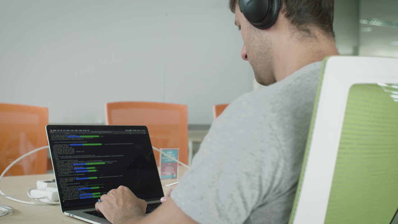 Software Developer Coding on Laptop in Digital Nomad Co Working Space. Freelancing and Remote Work Career Concept.