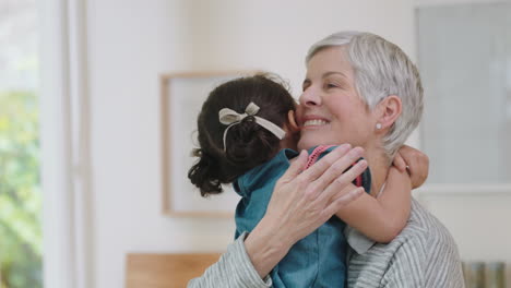 happy little girl hugging grandmother smiling embracing granddaughter loving granny enjoying affection at home family concept 4k footage