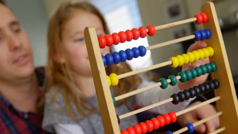 father and daughter playing with abacus in living room 4k