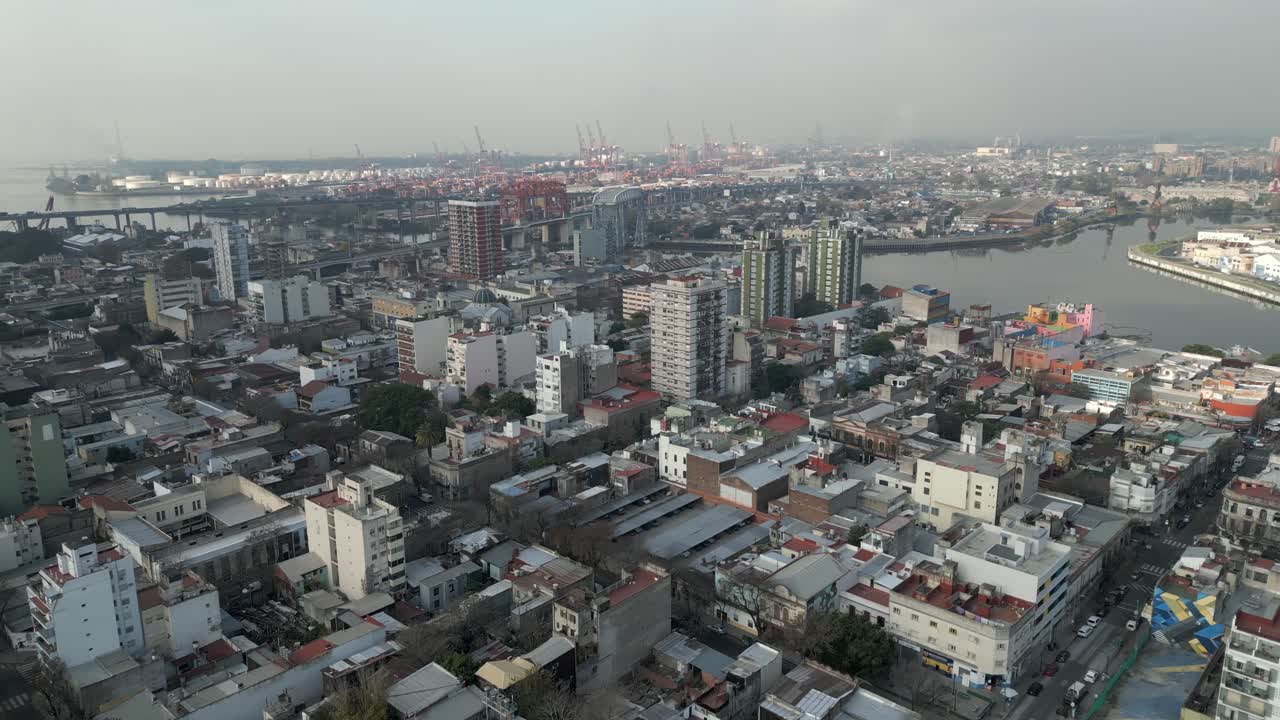 A bird's eye view of La Boca, with the Nicolás Avellaneda Bridge and the Port of Buenos Aires in the background