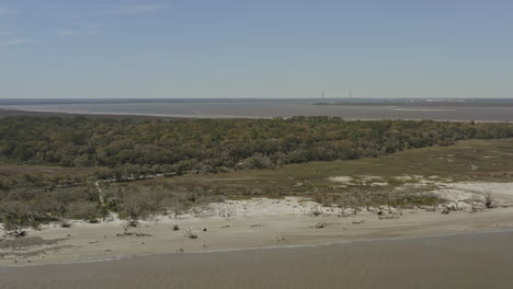 jekyll island georgia aerial v1 pan left shot of forest, beach and atlantic ocean - march 2020