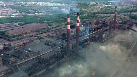 industrial area fly over, drone shot of factory tubes and plants