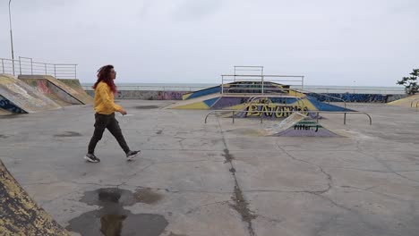 woman walking in a skatepark near the ocean