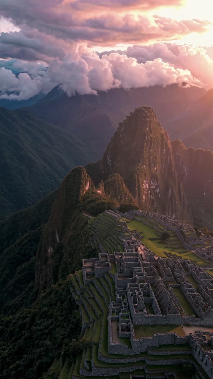 Aerial view of Machu Picchu at sunset, capturing the ancient ruins and surrounding mountains
