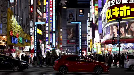 crowded street with neon signs and passing cars