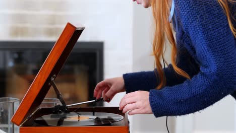 Beautiful-woman-adjusting-compact-disk-in-turntable-4k
