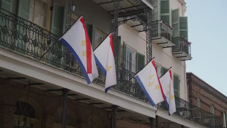 new orleans city flags on french quarter balcony