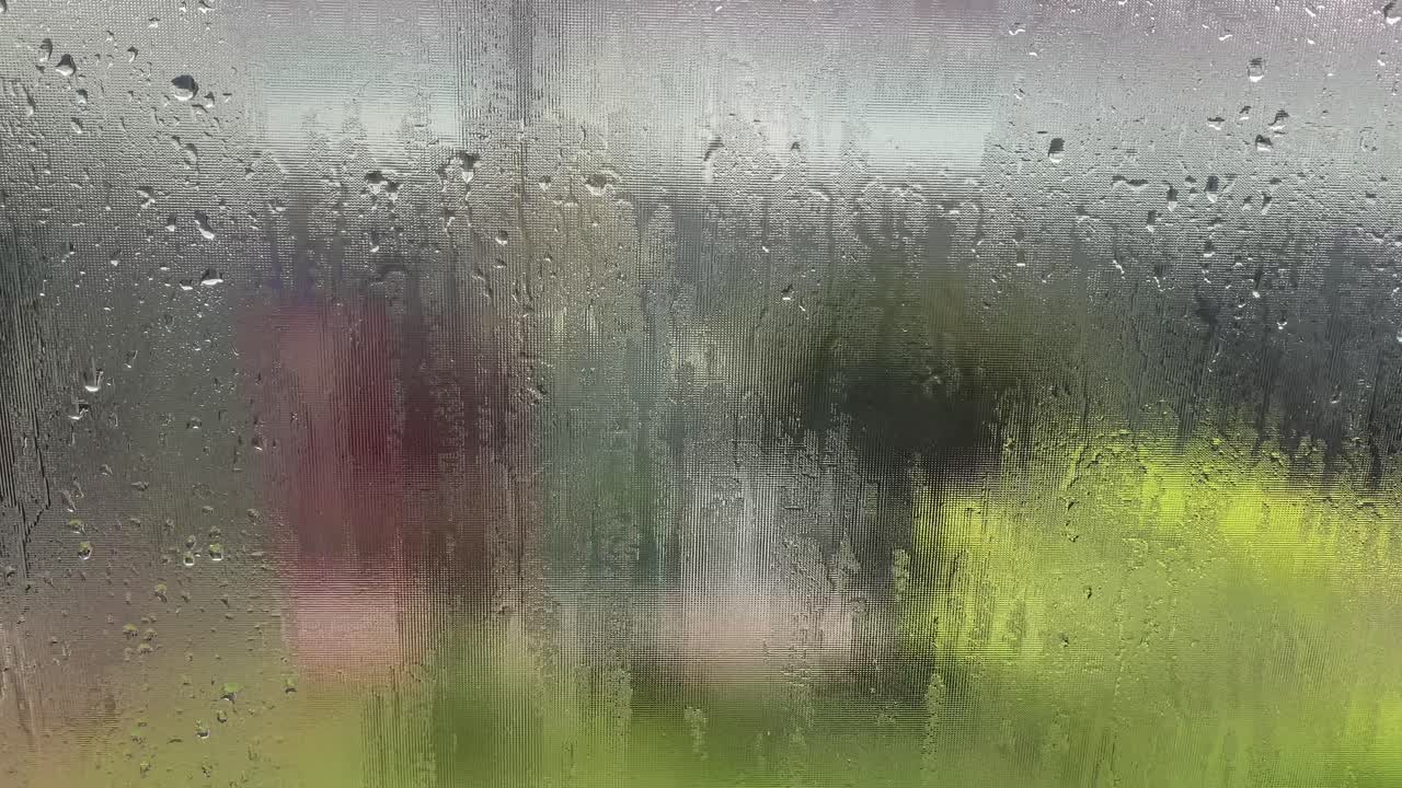 Rain drop on window over blurred nature background, rainy season background idea