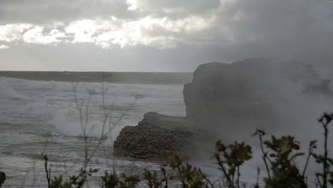 Big-waves-hitting-the-abandoned-concrete-coast-defense-building-in-stormy-weather-in-slow-motion