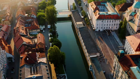 Butcher's-Bridge-And-Dragon-Bridge-Across-Ljubljanica-River-In-Ljubljana,-Slovenia-On-A-Sunny-Morning