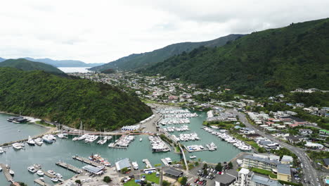 Boats-moored-in-Picton-pier-with-cityscape-around,-aerial-drone-view